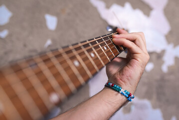 Man playing acoustic guitar close up.