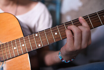 Man playing acoustic guitar close up.