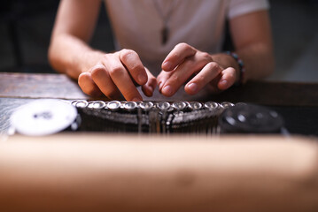 Man typing text on an old typewriter close up.