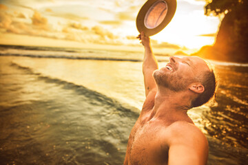 nice man taking selfie portrait on beach