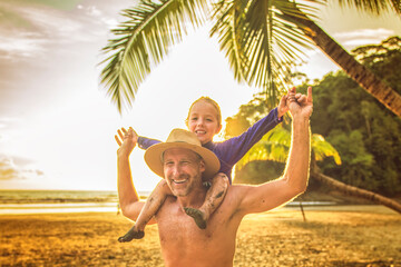 nice man having great time on beach with his daughter