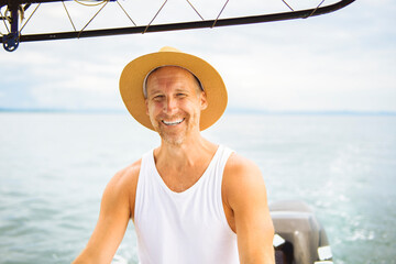Man captain driving boat on ocean tour