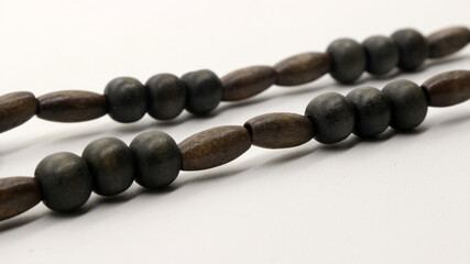 Close up of round wooden necklace isolated