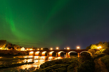 Aurora borealis, The Northern lights over old brick bridge. Kuldiga, Latvia.