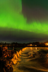 Aurora borealis, The Northern lights over Venta waterfall. Kuldiga, Latvia.