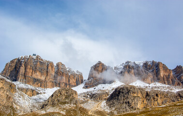Fototapeta na wymiar the Belluno Dolomites on the Pordoi pass in spring with clouds, fog and a cool temperature