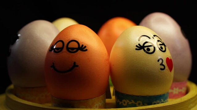Easter eggs with jokes. Colorful Easter eggs with different funny faces pasted on them. Easter holiday.