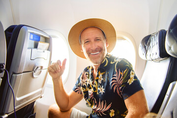 handsome adult male passenger having great time on flight.