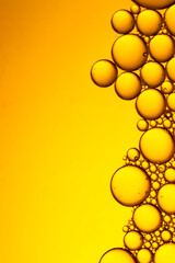 Vertical shot of  an Yellow bubbles and drops of oil background . Yellow water bubbles wallpaper ....