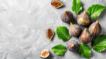 Fototapeta premium ripe figs, adorned with leaves, against a soft, light background, evoking a sense of freshness and abundance.