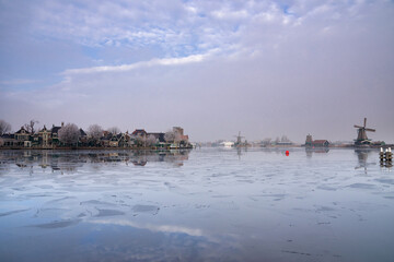View over a frozen river Zaan to Zaandijk