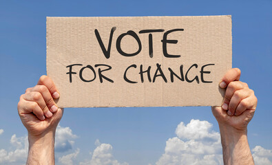 Hands holding a sign with the inscription: vote for change