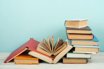 Open book, hardback colorful books on wooden table. Back to school. Copy space for text. Education business concept.