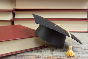 education concept. Graduation hat with gold tassel on the books. Law concep- with copy space for...