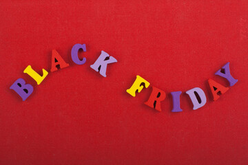 BLACK FRIDAY word on red background composed from colorful abc alphabet block wooden letters, copy...