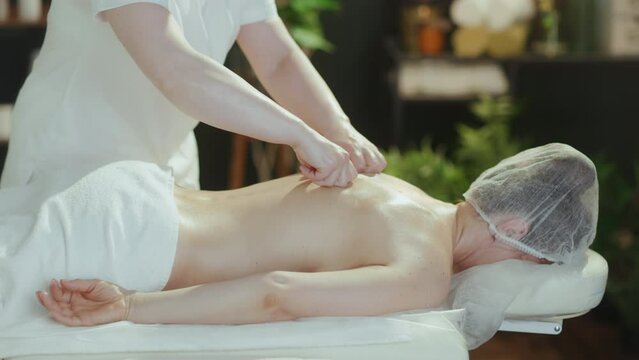 Healthcare time. massage therapist in spa salon do a therapeutic massage on massage table.