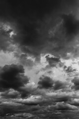 Obraz premium Storm sky with dark grey black cumulus clouds abstract background texture, thunderstorm. Black and white photo