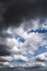 Storm cloudy dramatic sky with dark rain grey cumulus cloud and blue sky background texture,...