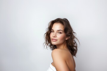 Fototapeta premium Beautiful brunette woman with long hair, radiant perfect skin, beauty industry, beauty and health.