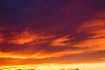 red clouds on the sky at dusk. dramatic nature background. weather change before the rain
