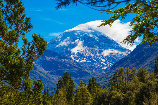 Lanin volcano surrounded by clouds, clear summit in sight and ice glaciers, between Argentina and Chile, Lanin National Park