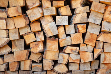 Pile of sawn wood logs ready for winter, close up.. Background of chopped firewood logs. wood texture.