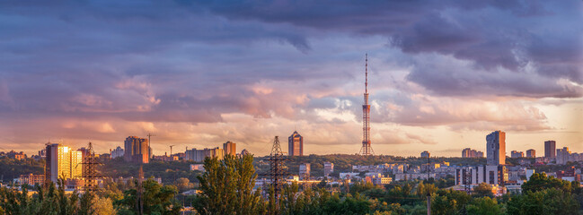 The sunset light illuminated the city skyline with picturesque clouds in the sky. Kyiv, Ukraine.