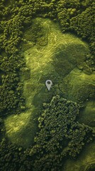 Aerial view of a dense forest with a map pin icon