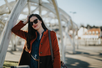 A professional businesswoman wearing sunglasses and a stylish jacket strikes a pose, exuding...