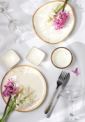 Elegant festive table setting, menu layout in a cafe or restaurant, cutlery with flowers on a plate...