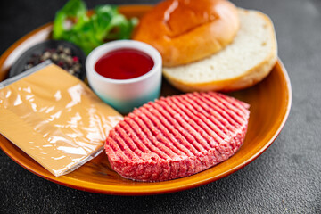 raw burger set cutlet, bun, cheese, tomato sauce, greens fresh cooking appetizer meal food snack on the table copy space food background 