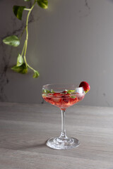 a cocktail with strawberries and basil