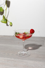a cocktail with strawberries and basil