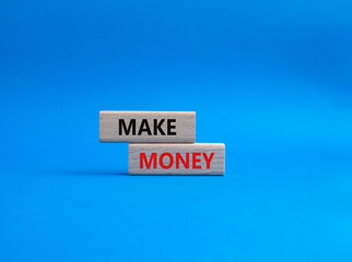 Make Money symbol. Wooden blocks with words Make Money. Beautiful blue background. Business and Make Money concept. Copy space.