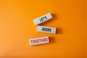 Lets work together symbol. Concept words Less is More on wooden blocks. Beautiful orange...