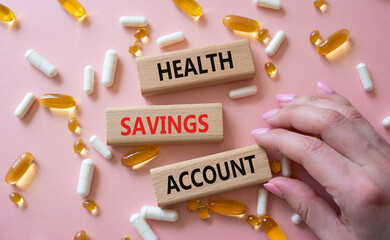 Health Saving Account symbol. Concept word Health Saving Account on wooden blocks. Doctor hand....