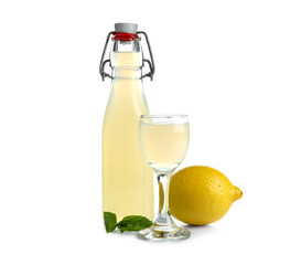 Glass and bottle of tasty Limoncello on white background