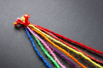 Colored threads pinned together as a concept of unity, team and diversity.