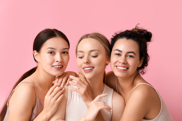 Happy young women on pink background