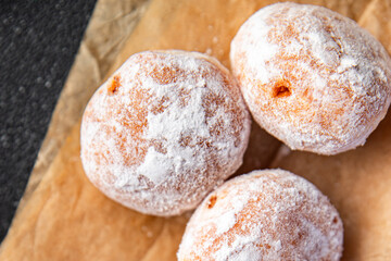 donut filled with powdered sugar
chocolate filling fresh appetizer meal food snack on the table...