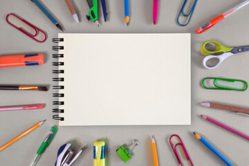 Notepad and stationery. Template with copy space school theme. Pens pencils paint brushes scissors...