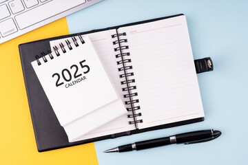 Notepad and 2025 calendar New Year concept