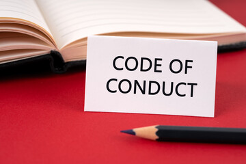 Code of conduct text on paper note red background