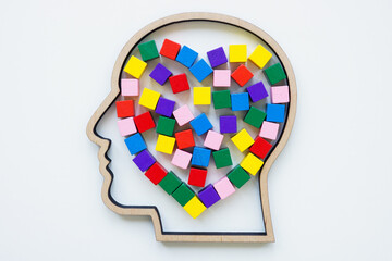 Outline of a head and a heart made of colored cubes as a symbol of autism.