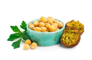 Bowl with chickpea, delicious falafel balls and parsley on white background