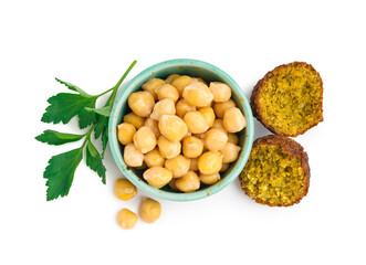 Bowl with chickpea, delicious falafel balls and parsley on white background
