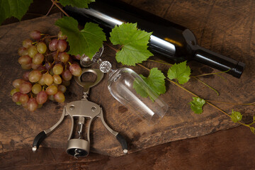 Still life with empty wine glass and grapes on vintage wooden background..