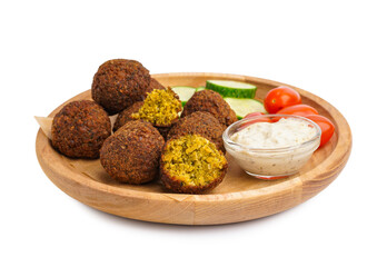 Wooden plate with delicious falafel balls, sauce and vegetables on white background
