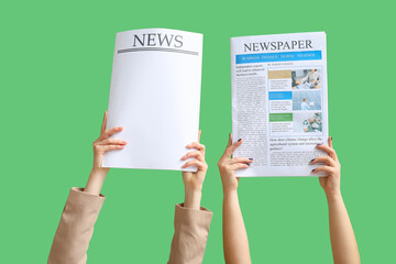 Female hands holding newspaper and paper sheet with word news on green background