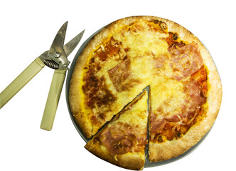 Pizza on a plate with a slice and scissors, top view